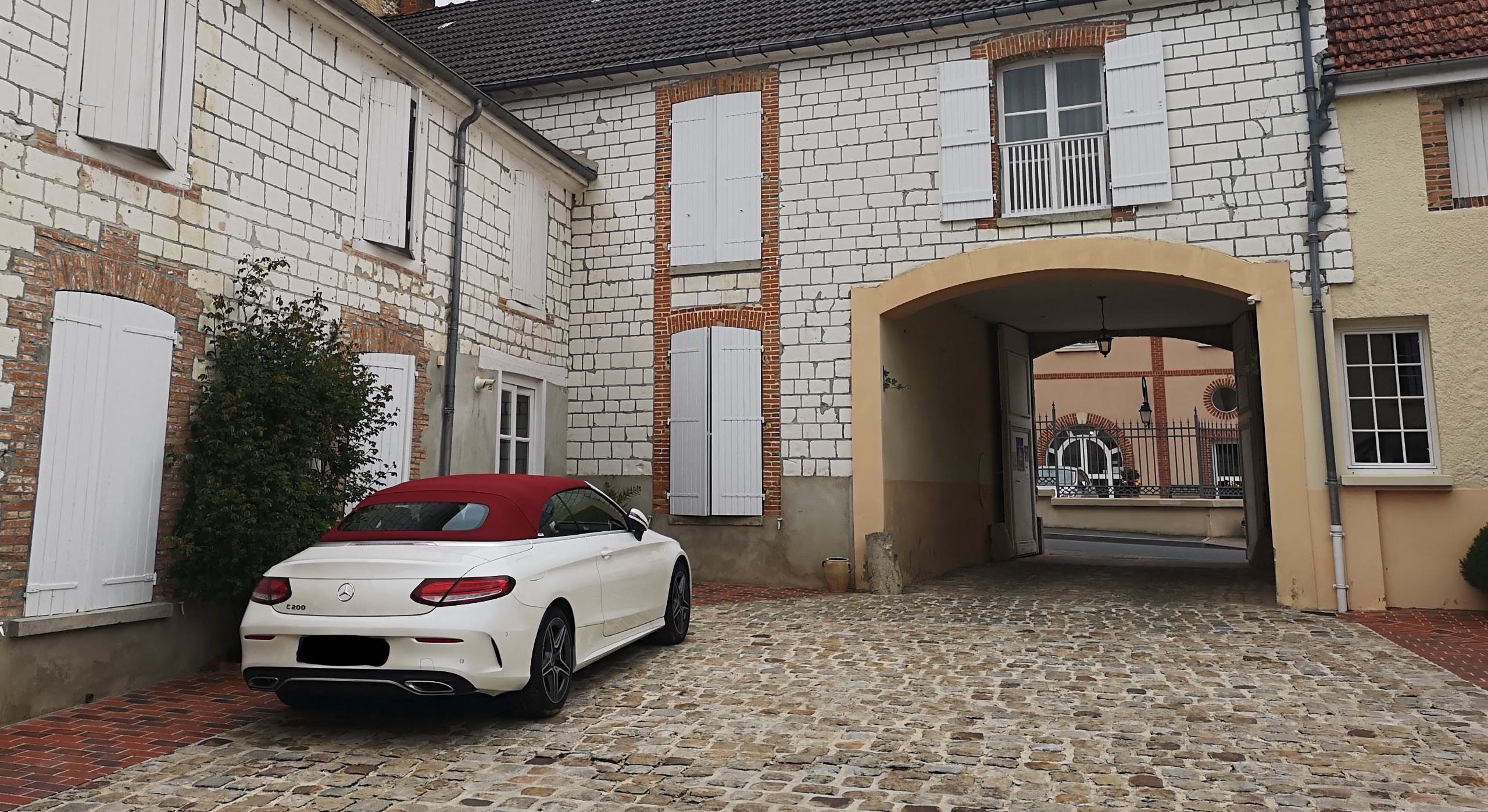 A Mercedes parked outside of a house