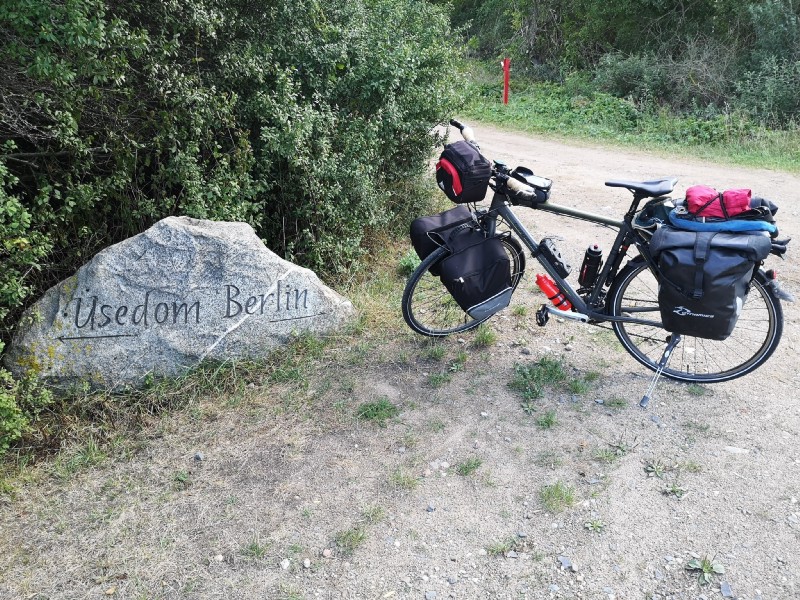 A bycicle next to a sign